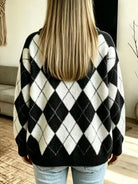 NEWYORKLISTED STYLE COLLECTION: A person viewed from behind wearing a black and white argyle knit sweater, paired with light blue jeans, in a brightly lit indoor room.
