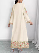 NEWYORKLISTED STYLE COLLECTION: Beige embroidered dress worn by a model on a white background