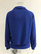 NEWYORKLISTED STYLE COLLECTION: Blue sweater on a mannequin against a white background