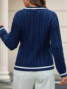 NEWYORKLISTED STYLE COLLECTION: Person wearing a blue cable knit sweater with white trim