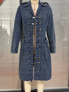 NEWYORKLISTED STYLE COLLECTION – Women's long blue denim military-style jacket featuring decorative gold buttons, structured collar, tailored silhouette, and long sleeves, styled with a white button-down shirt and blue jeans.