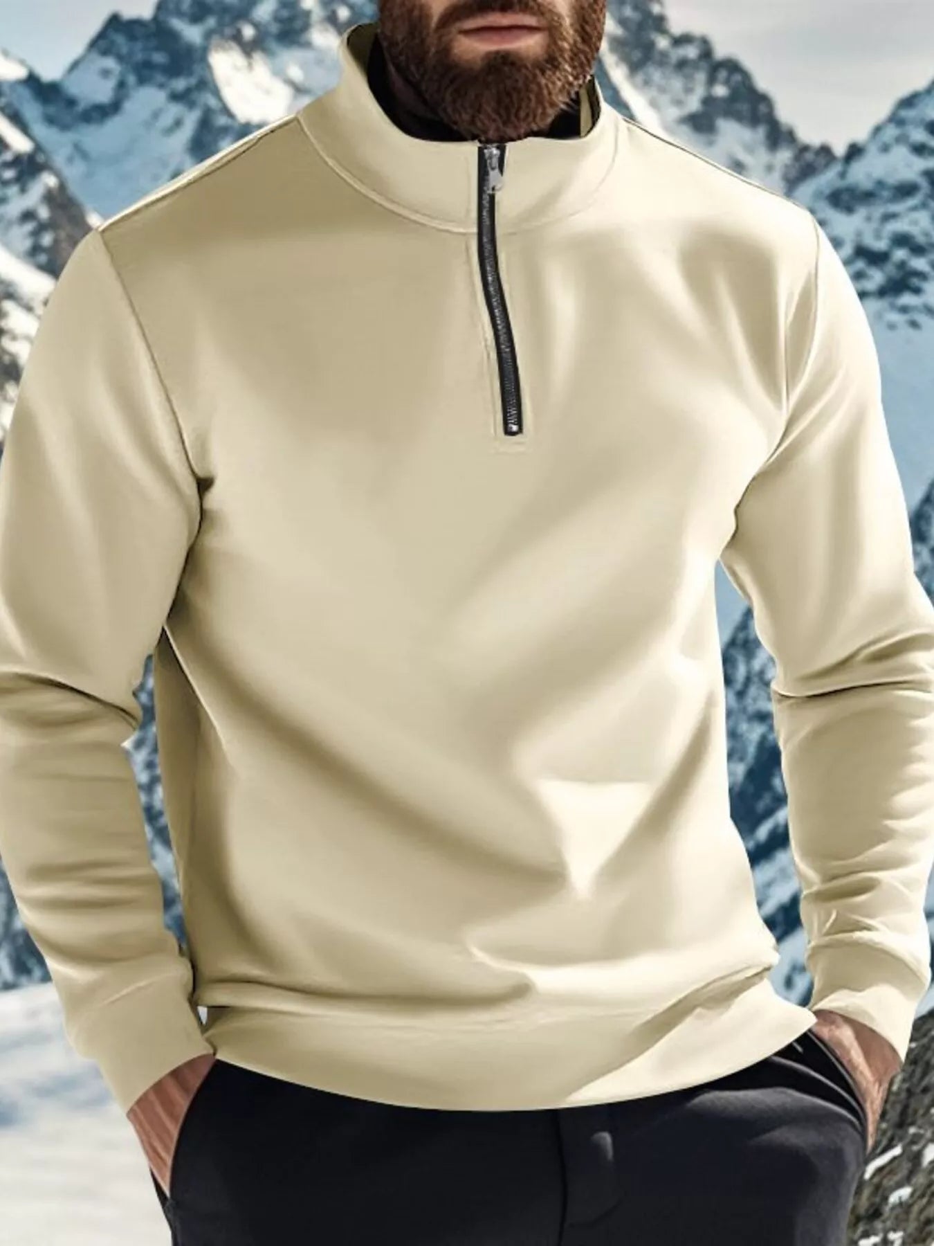 NEWYORKLISTED ATLAS MEN'S COLLECTION: Person wearing a beige pullover with a mountainous background