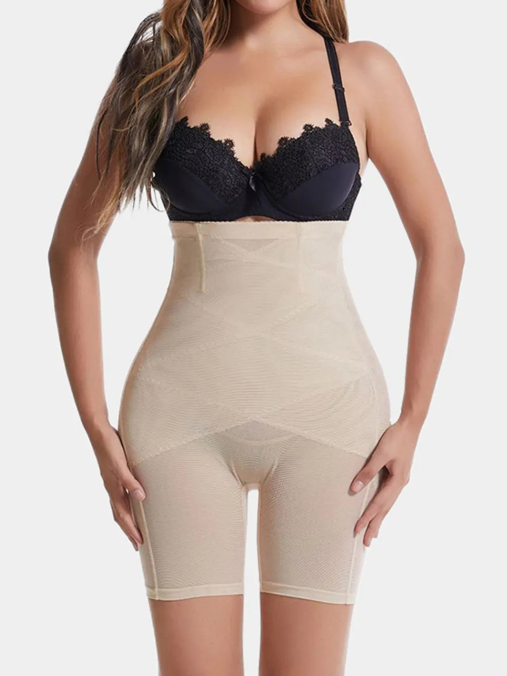 NEWYORKLISTED Intimate Apparel: Woman wearing a black lace bra and beige shapewear on a white background