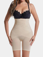 NEWYORKLISTED Intimate Apparel: Woman wearing a black lace bra and beige shapewear on a white background
