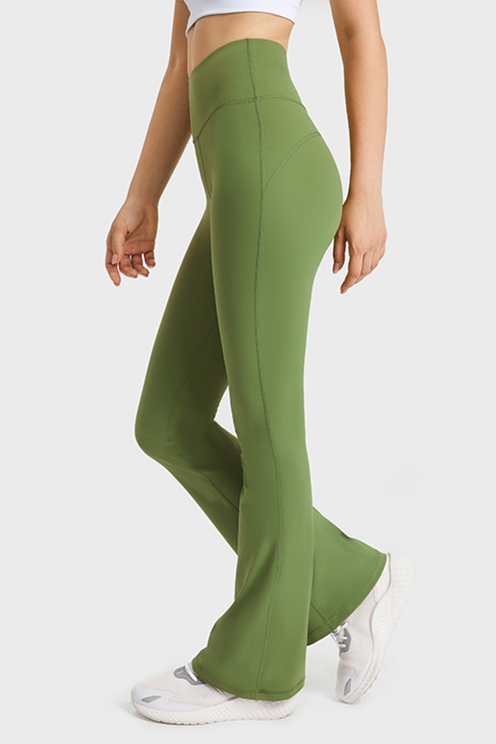 NEWYORKLISTED ACTIVEWEAR COLLECTION: Green flared pants worn by a person on a white background