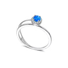 NYLD Glamour Collection by NEWYORKLISTED: Silver ring with a blue gemstone on a white background