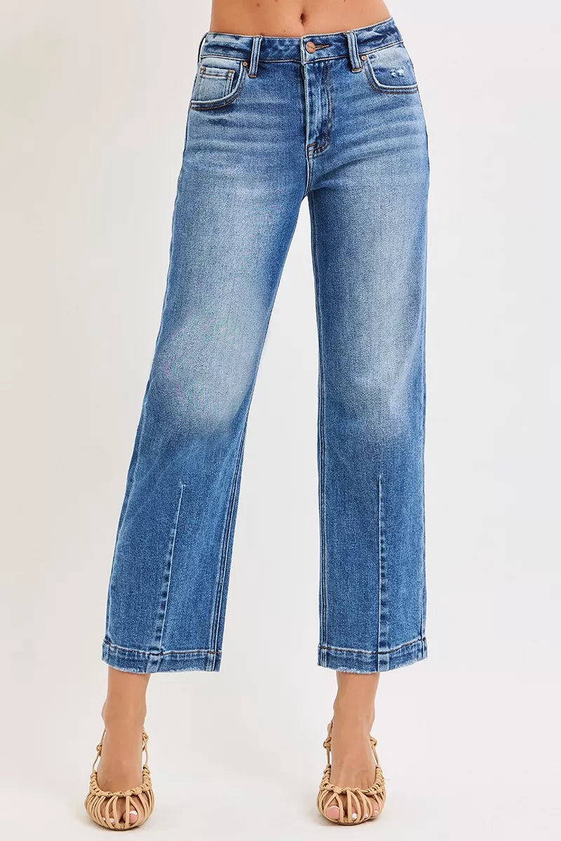 NEWYORKLISTED DENIM COLLECTION: Blue jeans worn by a person on a white background