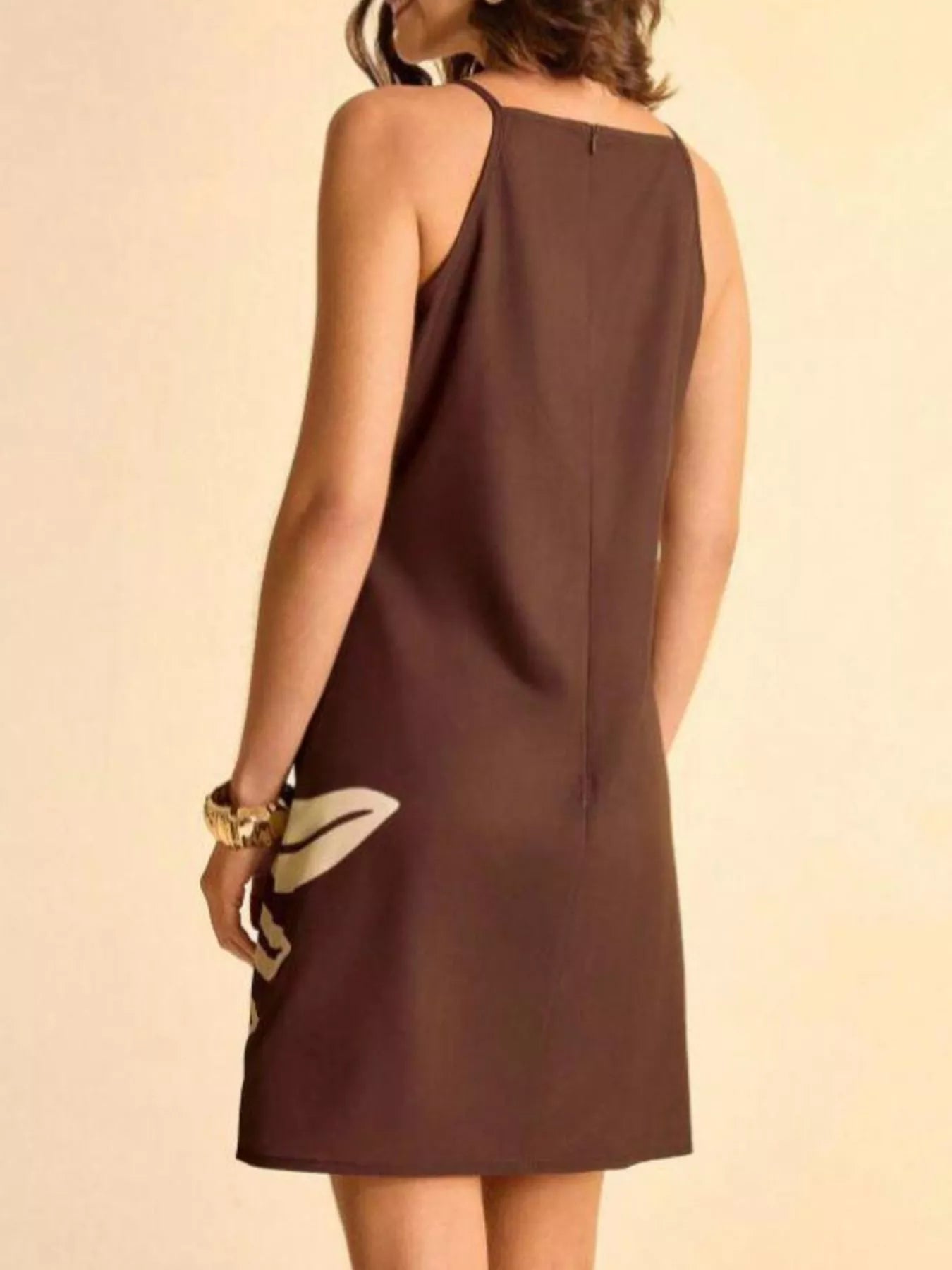 NEWYORKLISTED STYLE COLLECTION: Brown dress worn by a person on a beige background