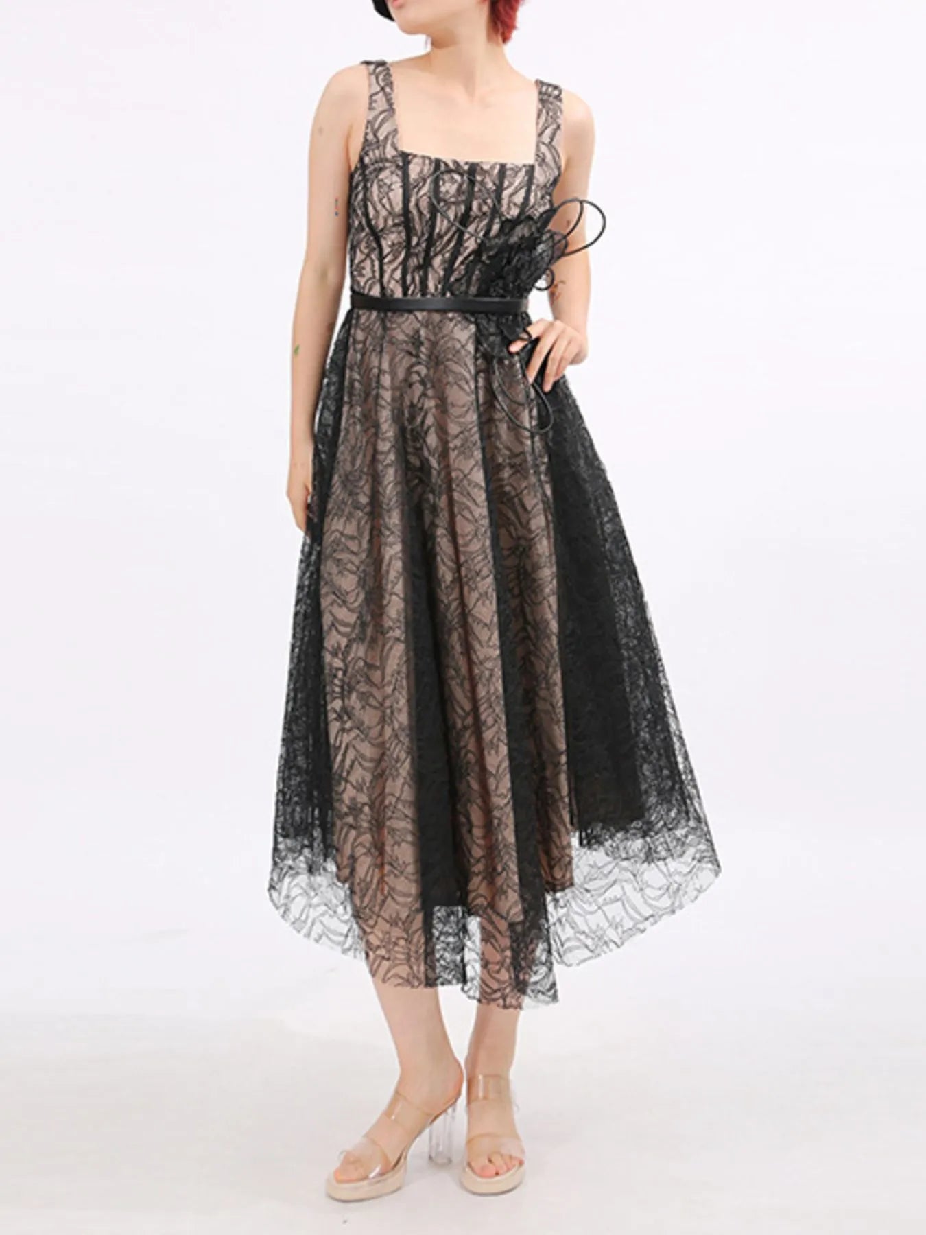 NEWYORKLISTED RUNWAY STYLE: Black lace dress worn by a model on a white background