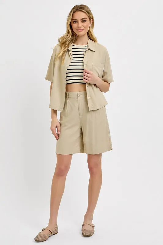 NEWYORKLISTED STYLE COLLECTION: Woman wearing a beige outfit with a striped top on a white background