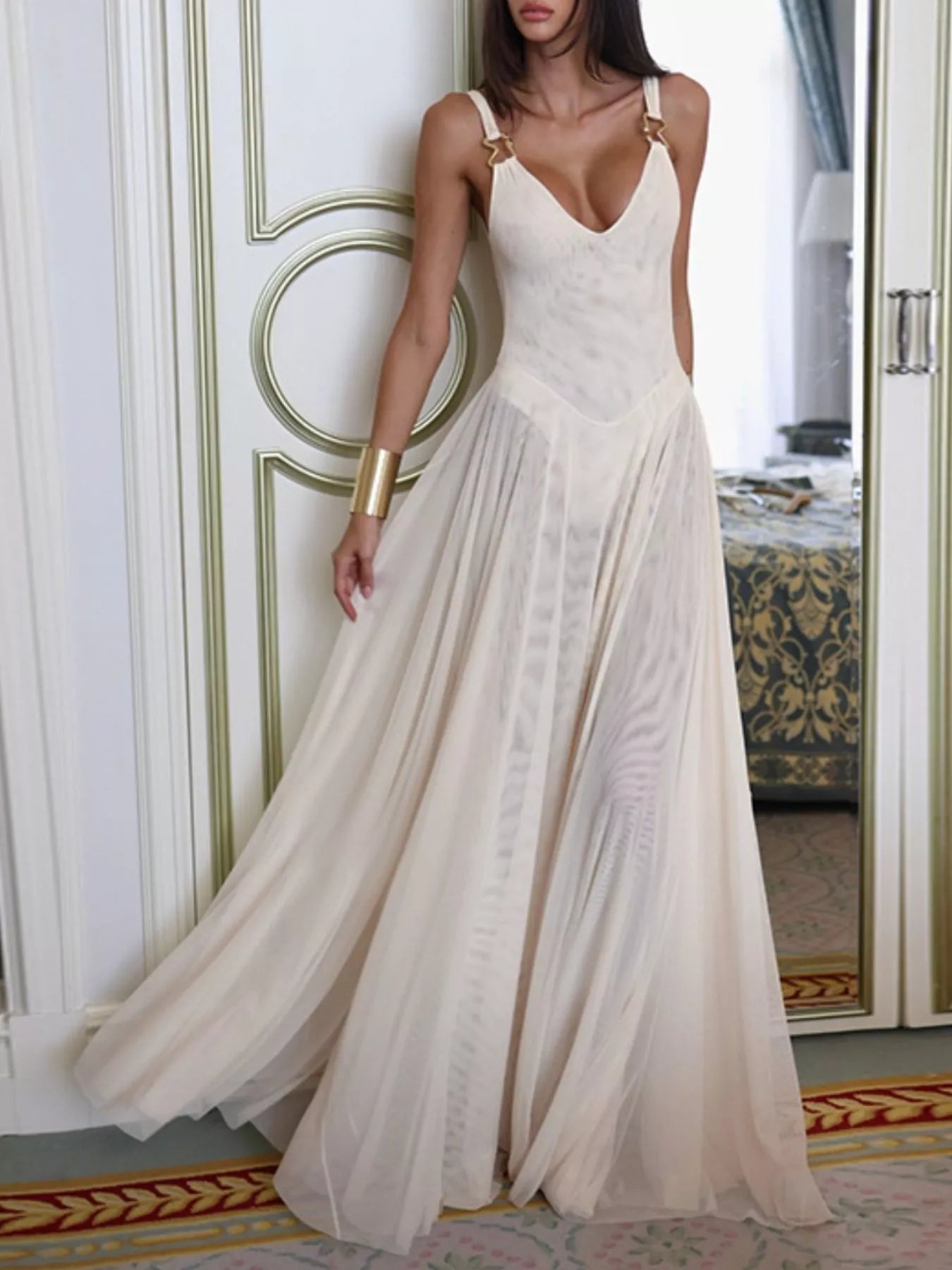 NEWYORKLISTED STYLE COLLECTION: Woman wearing a flowing white dress in an elegant interior setting