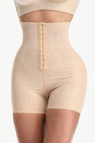 Beige shapewear with a zipper on a white background