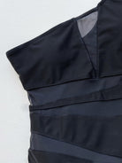 NEWYORKLISTED Eden Collection: One-Shoulder Sleeveless One-Piece Swimsuit Black strapless dress on a textured white background