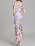 NEWYORKLISTED STYLE COLLECTION: Woman wearing a floral dress with a gray background