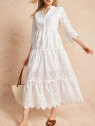 NEWYORKLISTED STYLE COLLECTION: Woman wearing a white lace dress against a beige background