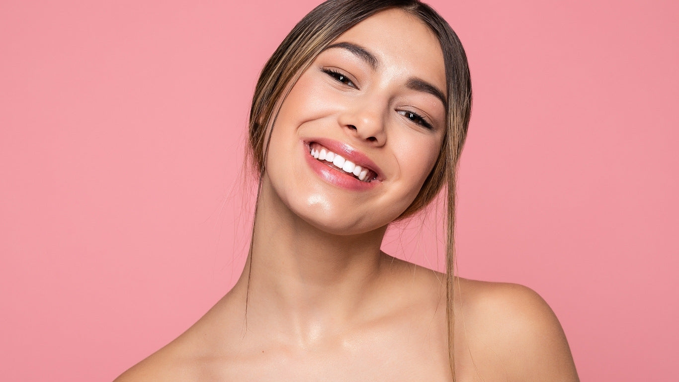 NEWYORKLISTED COSMETIC COLLECTION: Extreme Moisture Blend: Woman with a radiant smile against a pink background