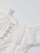 NEWYORKLISTED STYLE COLLECTION: White lace top with intricate detailing on a light gray background