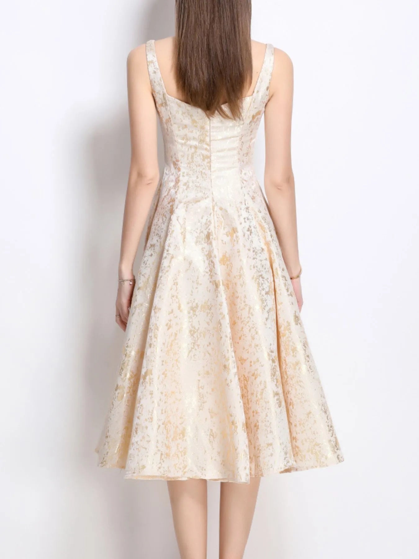 NEWYORKLISTED STYLE COLLECTION: Woman wearing a floral dress against a plain background