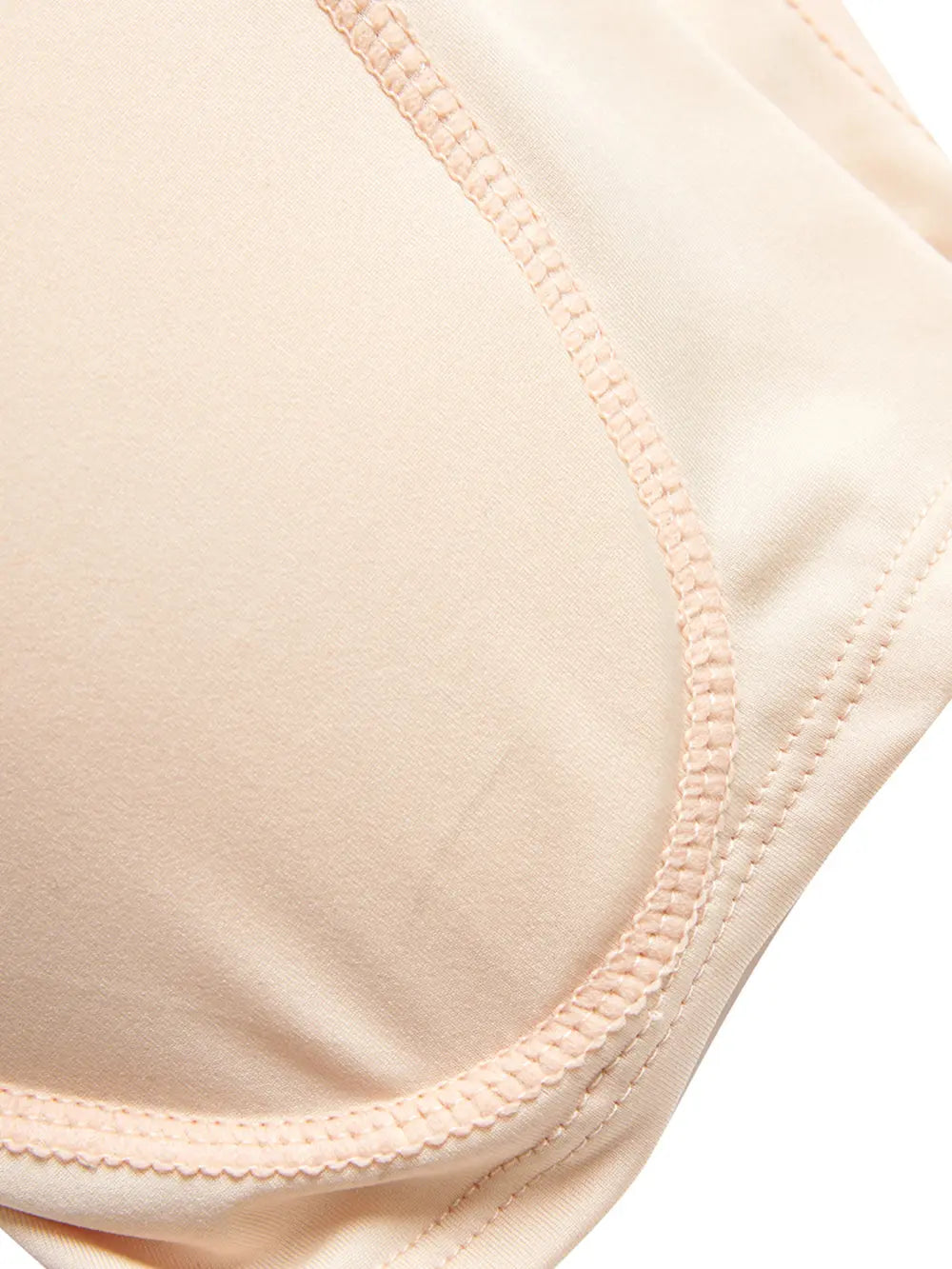 NEWYORKLISTED Intimate Apparel: Close-up of a beige bra strap on a white background