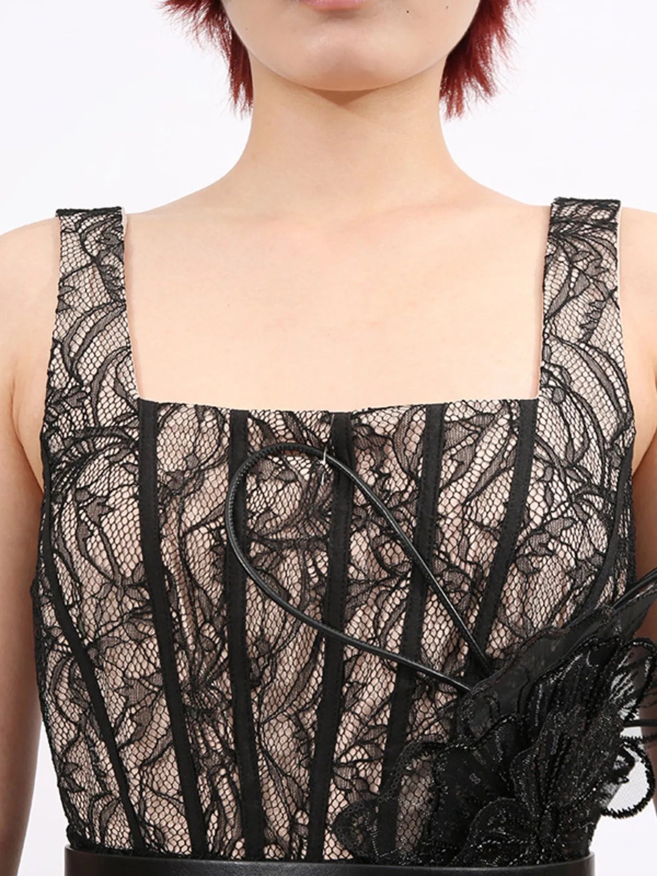 NEWYORKLISTED RUNWAY STYLE: Black lace top worn by a person on a white background