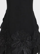 NEWYORKLISTED STYLE COLLECTION: Black dress with floral embroidery on a white background