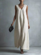 NEWYORKLISTED STYLE COLLECTION: Woman wearing a long white dress against a plain background