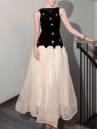 NEWYORKLISTED STYLE COLLECTION: Woman wearing a black top with white embellishments and a beige skirt.