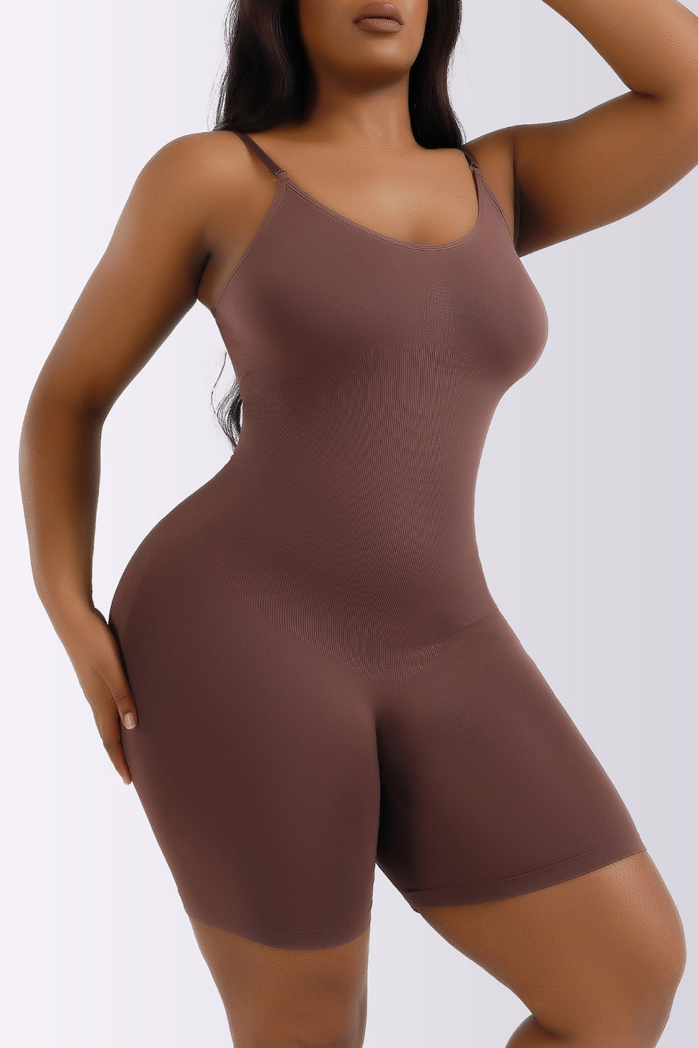 NEWYORKLISTED Intimate Apparel Collection: Woman wearing a brown bodysuit against a white background