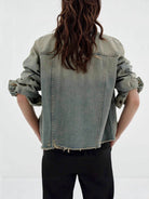 NEWYORKLISTED STYLE COLLECTION: Person wearing a light blue denim jacket on a white background