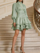 NEWYORKLISTED STYLE COLLECTION: Woman wearing sage green ruffled lantern sleeve mini dress with tiered skirt