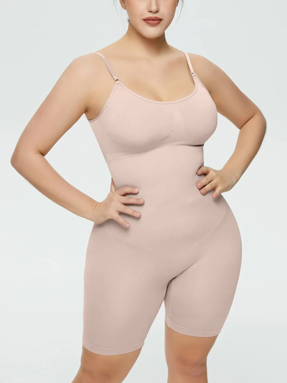 NEWYORKLISTED Intimate Apparel Collection: Woman wearing a beige shapewear bodysuit on a light gray background