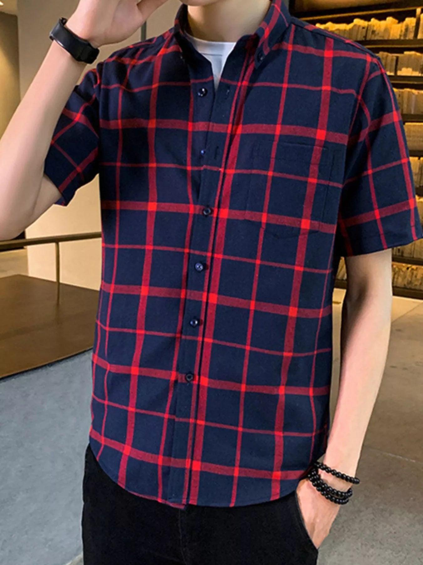 NEWYORKLISTED ATLAS MEN'S COLLECTION: Person wearing a red and blue plaid shirt indoors.