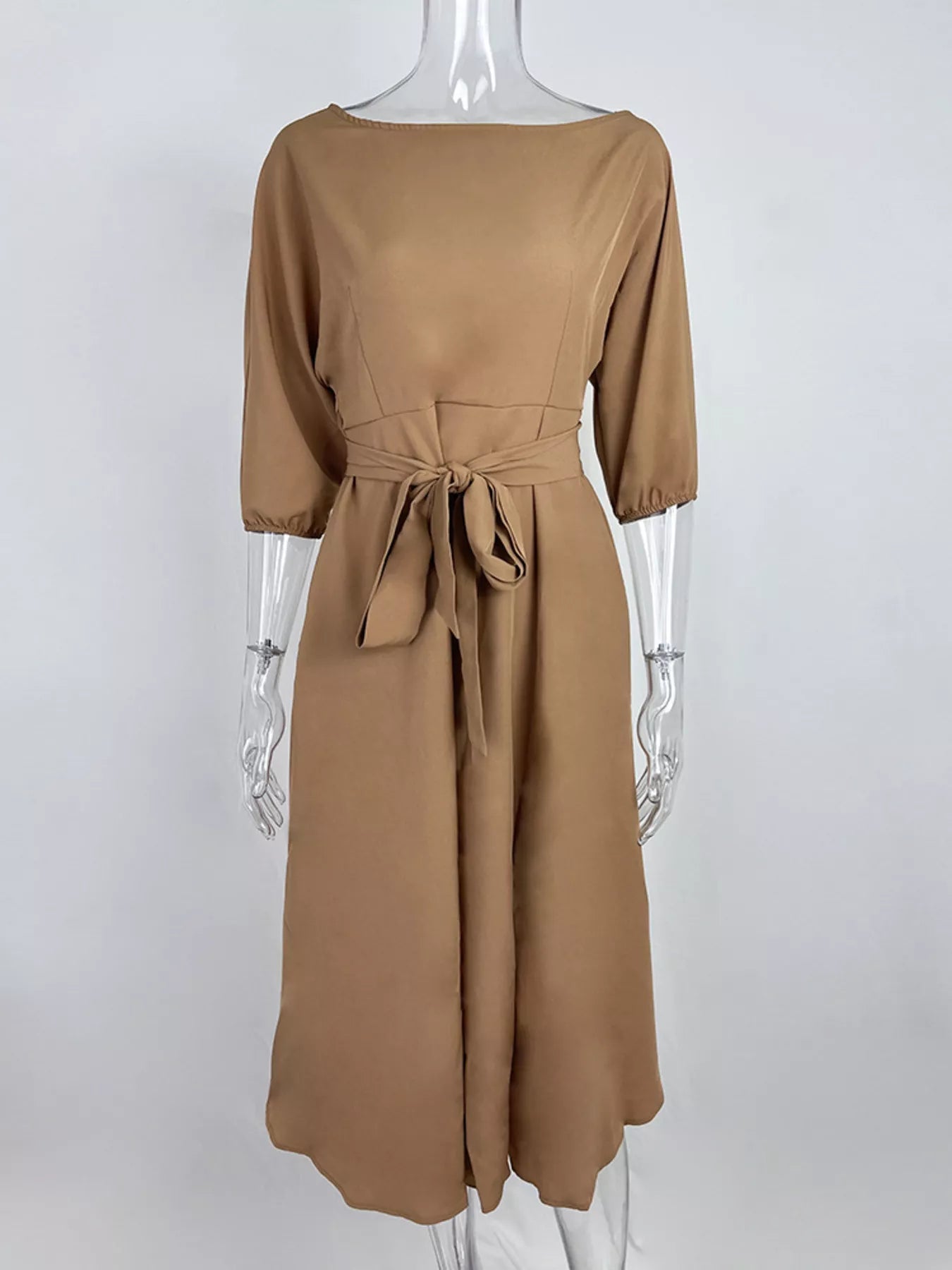 NEWYORKLISTED STYLE COLLECTION: Brown dress on a mannequin against a white background