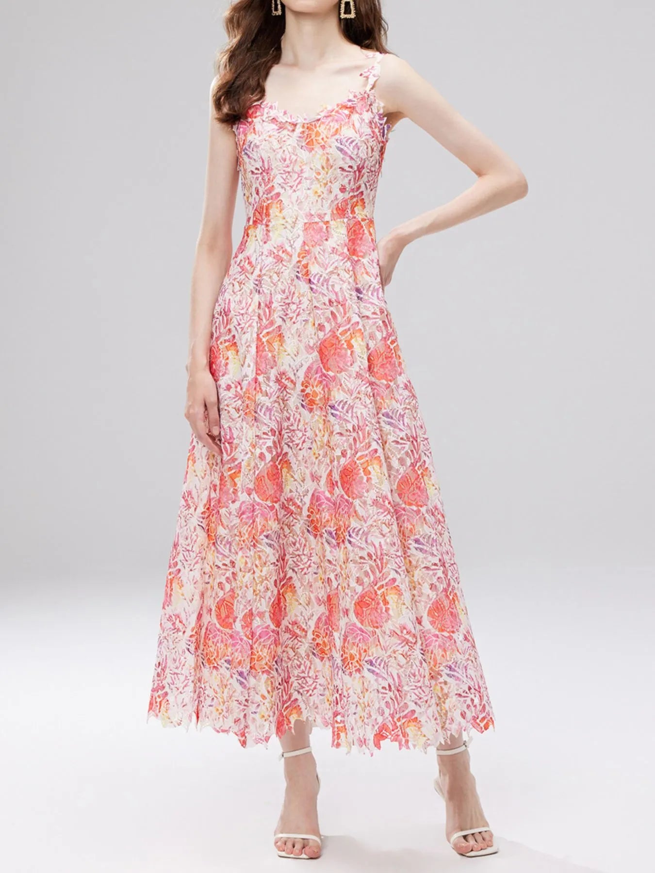 NEWYORKLISTED STYLE COLLECTION: Woman wearing a floral dress on a gray background
