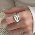 NYLD Glamour Collection: Hand wearing a silver ring on a light background