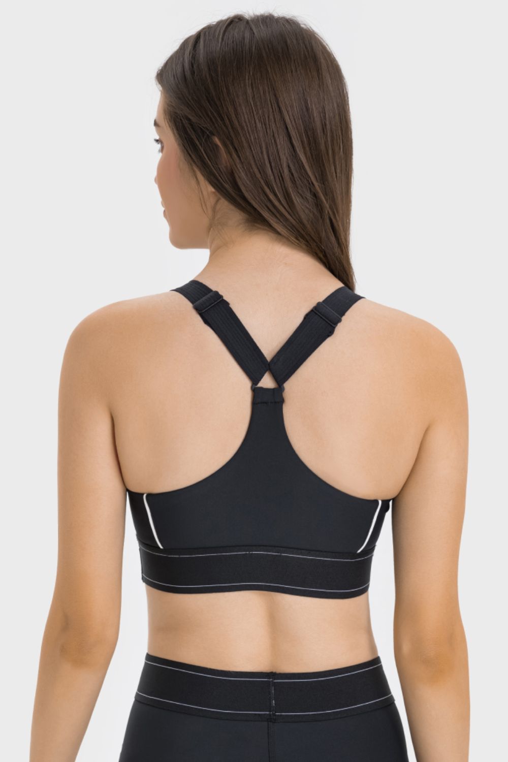 NEWYORKLISTED ACTIVEWEAR COLLECTION: Black sports bra worn by a person on a white background