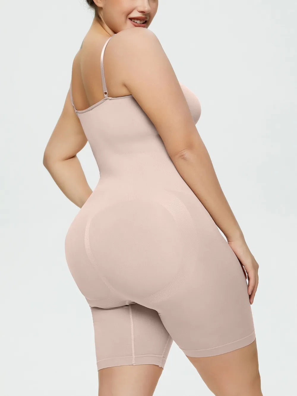 NEWYORKLISTED Intimate Apparel Collection: Woman wearing a beige shapewear garment on a plain background