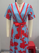NEWYORKLISTED STYLE COLLECTION: Red and blue patterned dress on a mannequin against a plain background