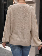 NEWYORKLISTED STYLE COLLECTION: Beige knitted sweater with a geometric pattern worn by a person, standing against a neutral background.
