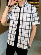 NEWYORKLISTED ATLAS MEN'S COLLECTION: Person wearing a black and white checkered shirt with a blurred indoor background