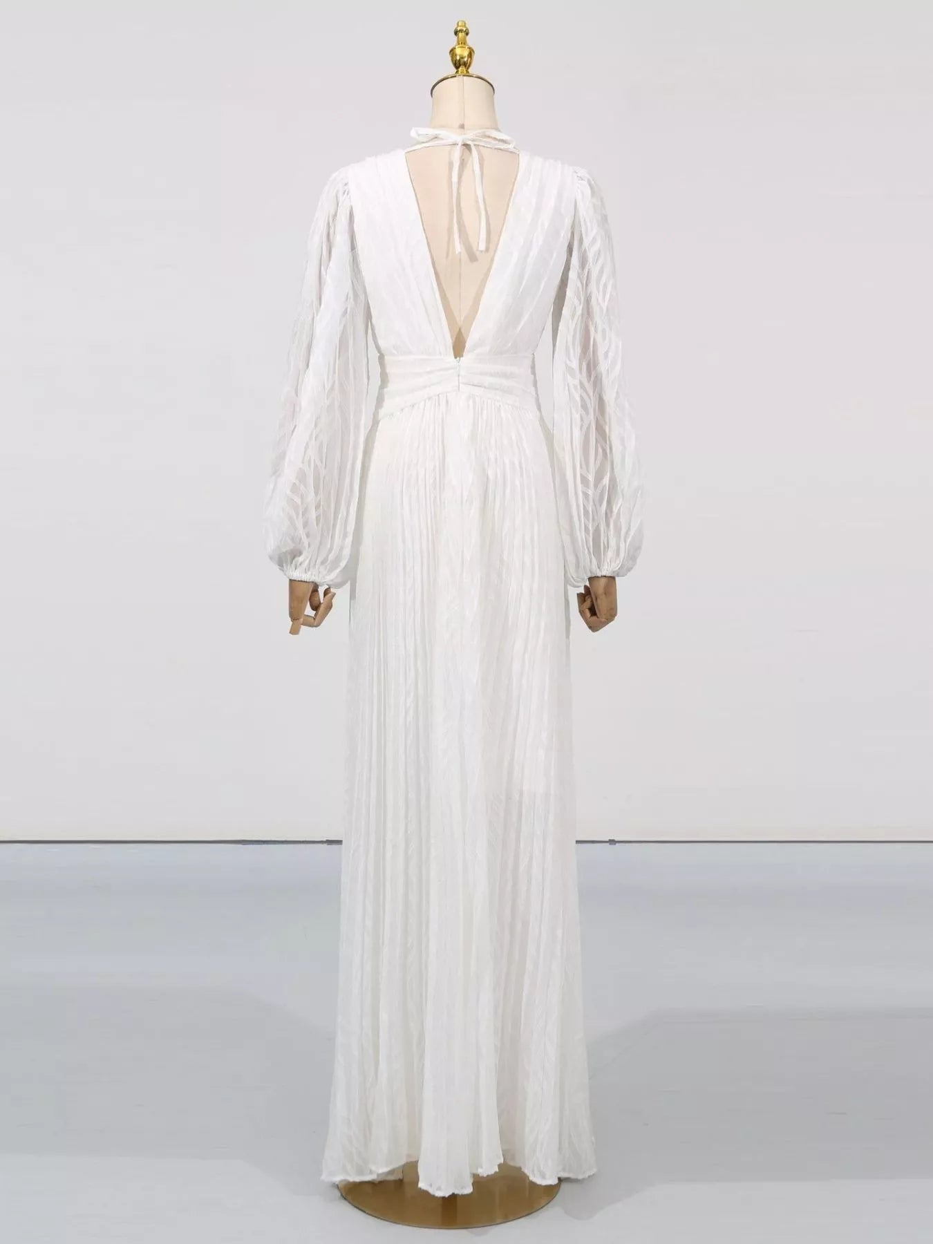 NEWYORKLISTED STYLE COLLECTION: White dress on a mannequin against a white background
