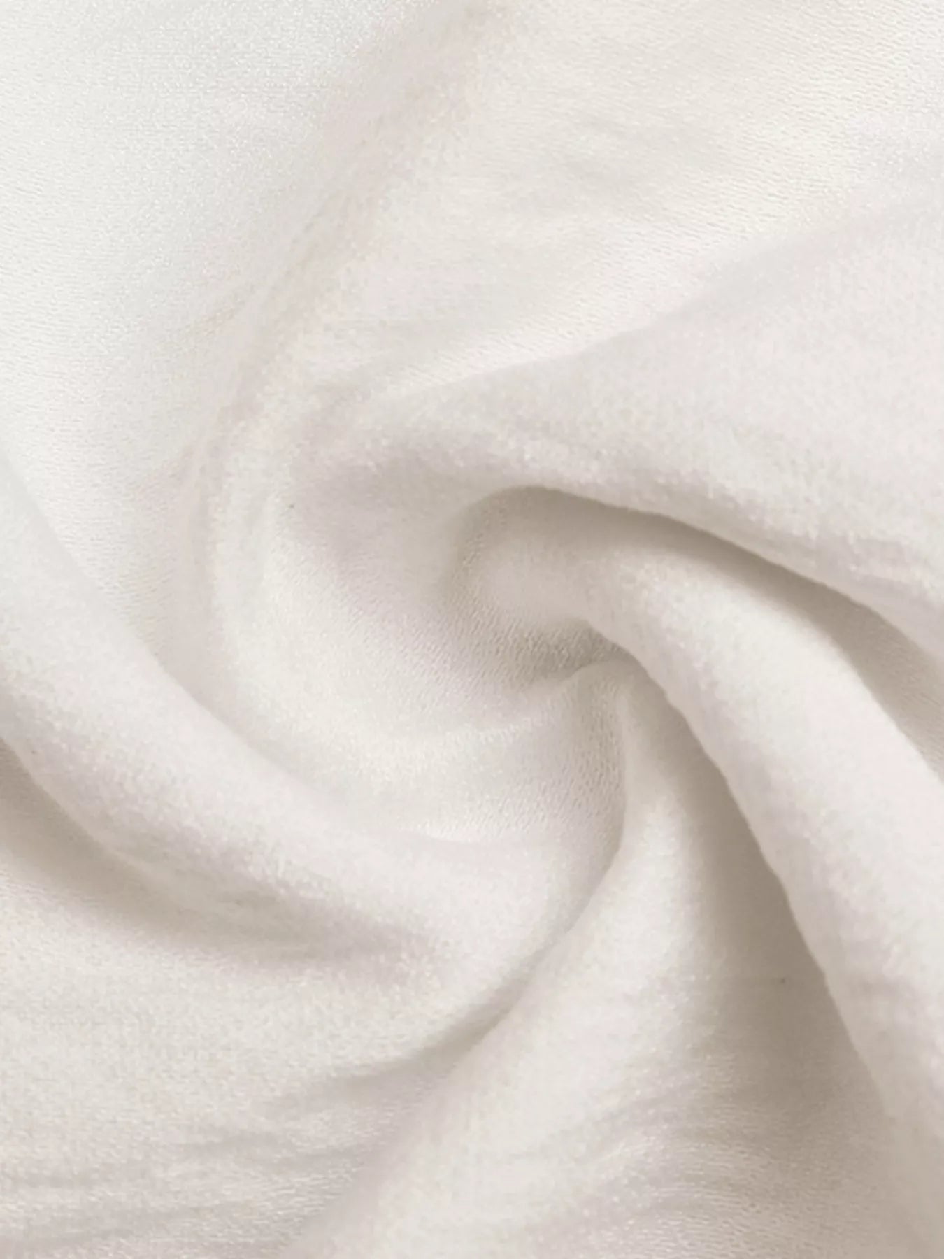 NEWYORKLISTED STYLE COLLECTION: Close-up of white fabric with a soft texture