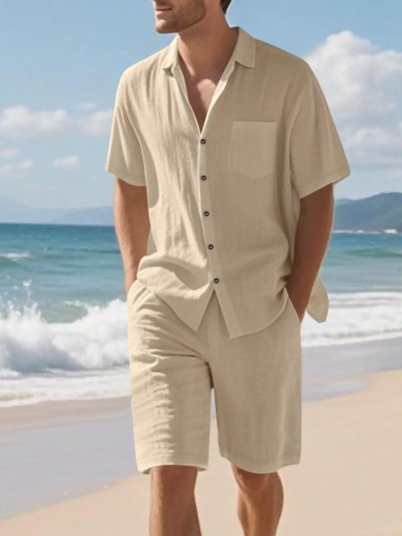 NEWYORKLISTED ATLAS MEN'S COLLECTION: Man wearing a beige outfit on a beach with ocean and sky in the background