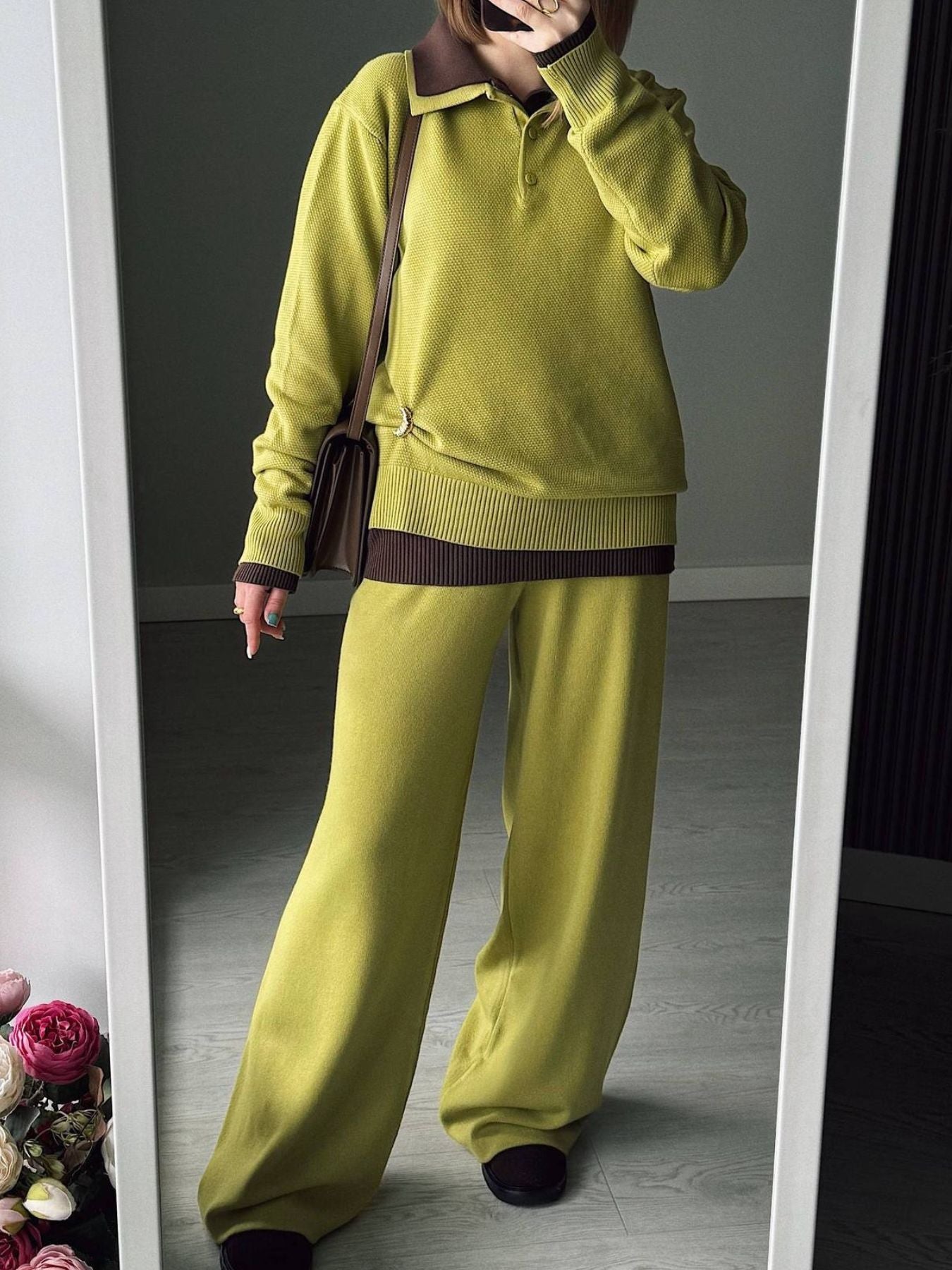 NEWYORKLISTED Comfort Collection: Person wearing a green sweater and pants standing in front of a mirror.