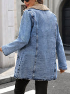 NEWYORKLISTED STYLE COLLECTION: A woman wearing a light blue denim jacket with a beige faux-fur collar, photographed from the back in an outdoor street setting.