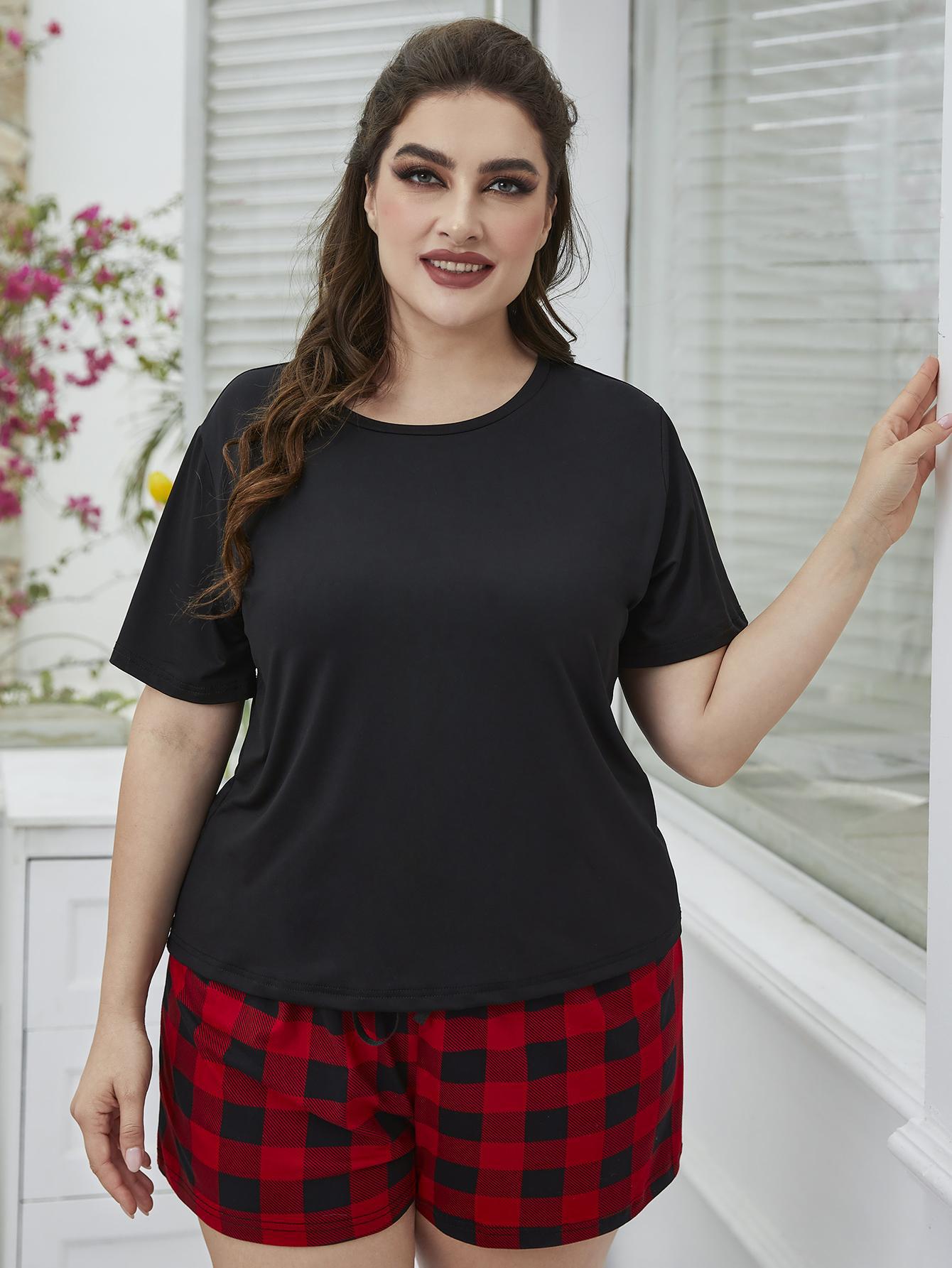 NEWYORKLISTED Intimate Apparel: Woman wearing a black top and red plaid shorts in a bright room.