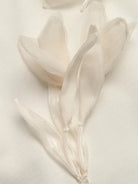 NEWYORKLISTED STYLE COLLECTION: Close-up of a white tulip on a light background