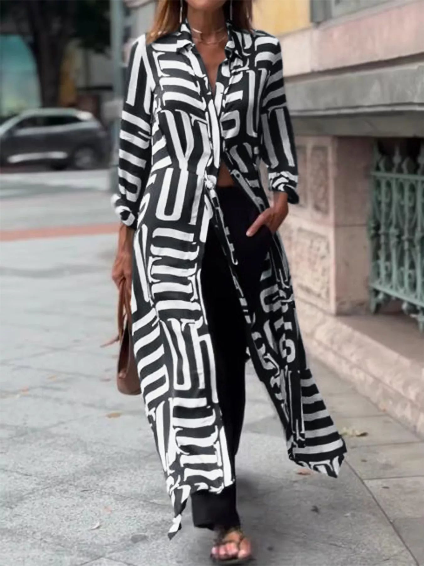NEWYORKLISTED STYLE COLLECTION Long Coat: Person wearing a black and white patterned outfit on a city street.