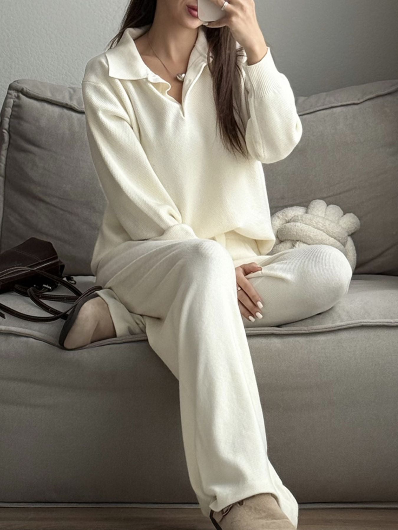 NEWYORKLISTED Comfort Collection: Person wearing a white outfit sitting on a gray couch.