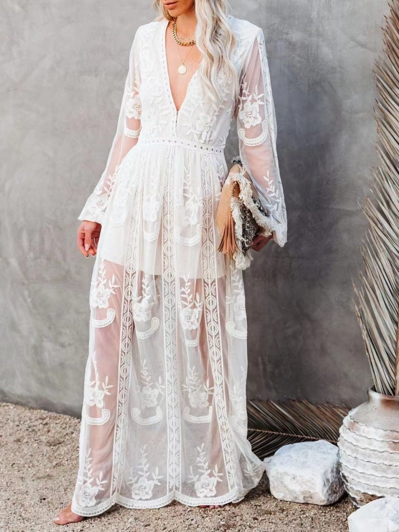NEWYORKLISTED STYLE COLLECTION: Woman wearing a white lace dress against a neutral background